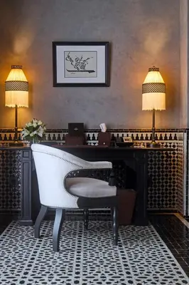 a living room with a white piano and a chair at Selman Marrakech in Marrakech