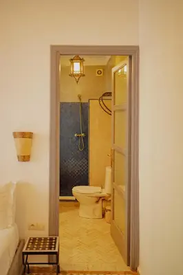 an open door to a bathroom with a toilet at Outsite Marrakesh in Marrakech