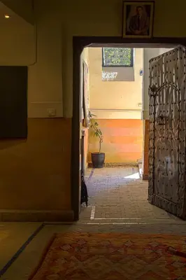 an open door to a hallway with a potted plant at Riad Laila in Marrakech