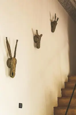 three head heads on a wall next to a staircase at Riad Laila in Marrakech