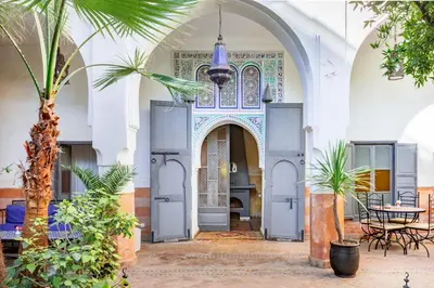 an entry to a mosque with a palm tree at Riad Laila in Marrakech