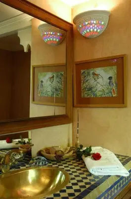 a bathroom with a sink and a mirror at Riad Dalia in Marrakech