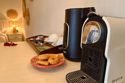 a toaster oven sitting on a counter with a plate of cookies at Riad Dar Salam Palm - 2025 Guest Choice Award in Marrakech