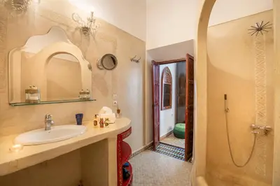 a bathroom with a sink and a shower at Riad Ben Tachfine in Marrakech