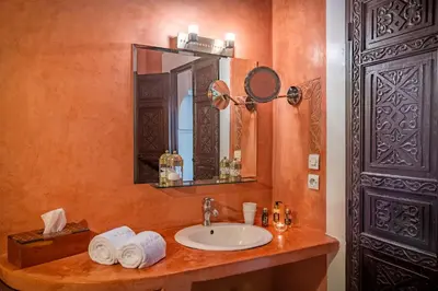 a bathroom with a sink and a mirror at Riad Ben Tachfine in Marrakech