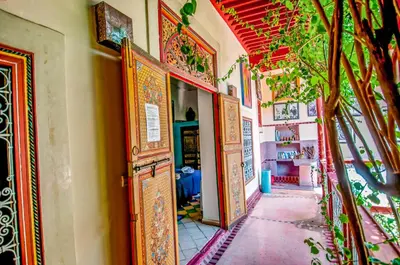 a hallway of a building with an open door at Riad Chorfa in Marrakech