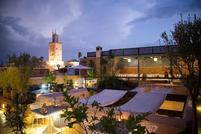 a building with a clock tower at night at Riad Olema et Spa in Marrakech