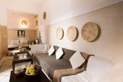 a living room with a couch and a table at Riad Olema et Spa in Marrakech