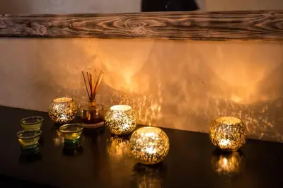 a group of candles on a table with lights at Riad Olema et Spa in Marrakech