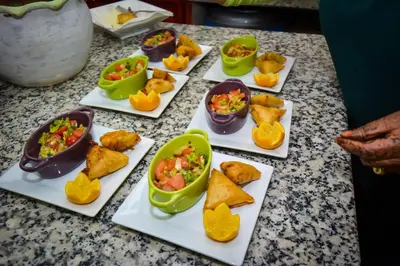 a table topped with dishes of food on plates at Riad Eloise in Marrakech