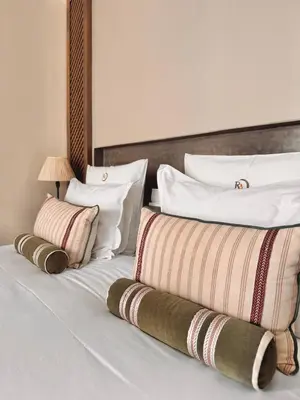 a bedroom with two beds with white pillows at Riad Abracadabra in Marrakech