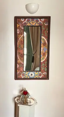 a mirror on a wall above a table with a sink at Riad Abracadabra in Marrakech