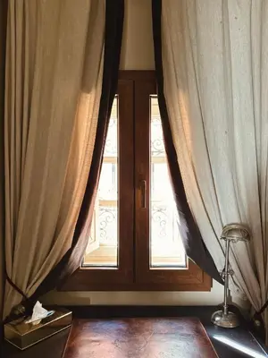 a window with curtains and a lamp in a room at Riad Abracadabra in Marrakech