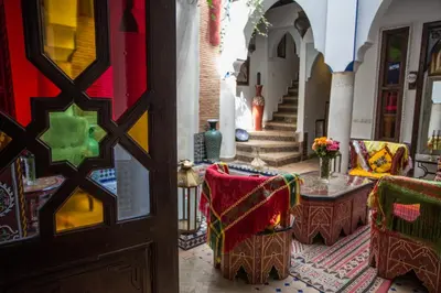an entrance to a room with chairs and a table at Riad Tamarrakecht in Marrakech