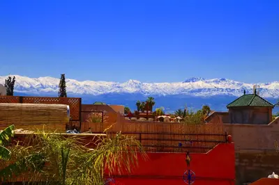 a view of snow covered mountains in the distance at Riad Villa El Arsa in Marrakech