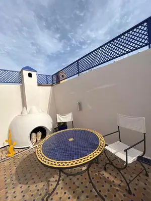 a patio with a table and chairs on a balcony at Riad Villa El Arsa in Marrakech