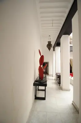 a vase sitting on a bench in a hallway at Riad Dar Asam in Marrakech