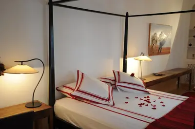 a bedroom with a bed with red and white pillows at Riad Dar Asam in Marrakech