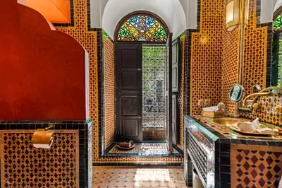 a bathroom with a shower and a sink and a window at Riad ILayka in Marrakech