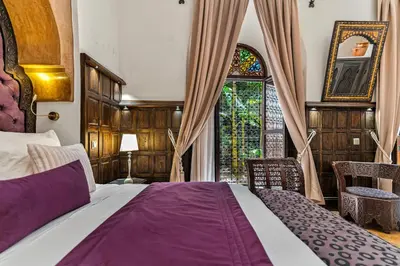 a bedroom with a large bed and a window at Riad ILayka in Marrakech