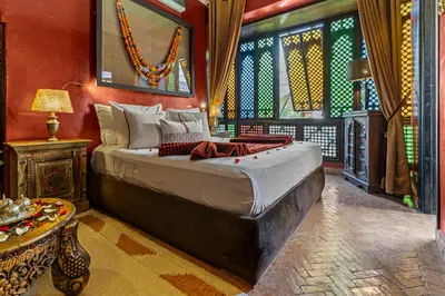 a bedroom with a large bed in a room at Riad ILayka in Marrakech