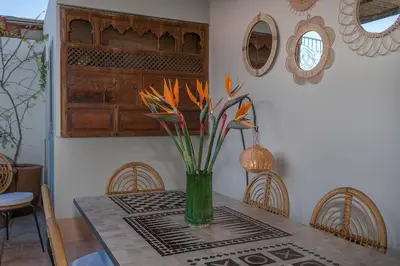 a vase of flowers on a table in a room at Riad Le J in Marrakech