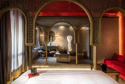 a bedroom with a bed and a mirror at Dar Kandi in Marrakech
