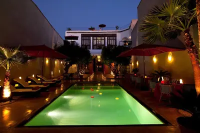 a swimming pool in the middle of a building at Riad Charaï in Marrakech
