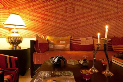 a living room with a couch and two candles on a table at Riad Charaï in Marrakech