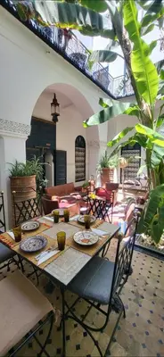 a table with plates on it in a room at Riad Aloes & Spa in Marrakech
