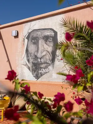 a painting of a man on the side of a building at Riad Mazaya in Marrakech