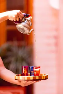 a person holding a tray with drinks on it at Riad Mazaya in Marrakech