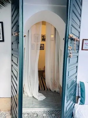 a doorway into a room with white curtains at Berber Duchess Riad in Marrakech