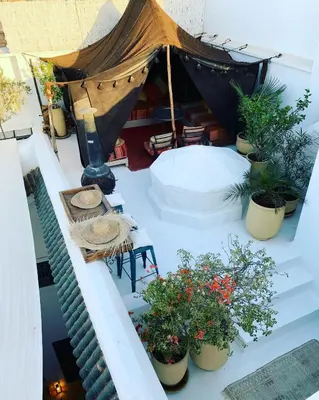 a balcony with a tent with potted plants on it at Berber Duchess Riad in Marrakech
