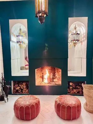 two red stools in a room with a fireplace at Berber Duchess Riad in Marrakech