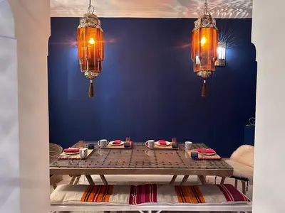 a table in a room with two chandeliers at Berber Duchess Riad in Marrakech