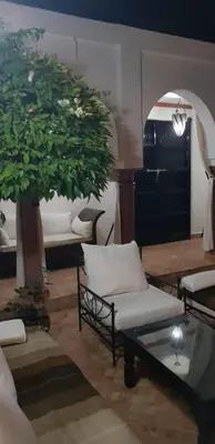 a living room with a tree and a couch and a table at Villa avec piscine a Marrakech in Marrakech