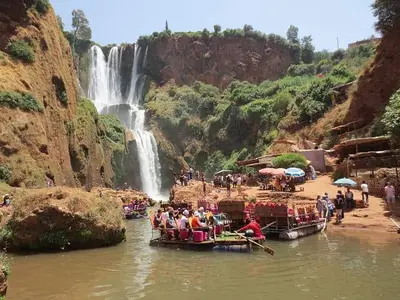 a group of people on boats in the water near a waterfall at Villa avec piscine a Marrakech in Marrakech
