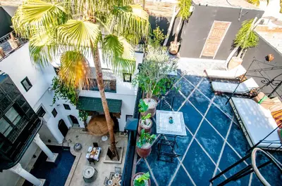 an overhead view of a swimming pool with palm trees at Riad Makila in Marrakech