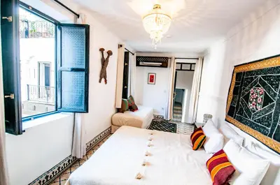 a small room with a bed and a window at Riad Makila in Marrakech