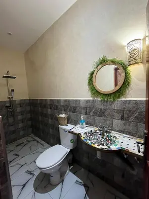 a bathroom with a toilet and a mirror at For You Riad Marrakech in Marrakech