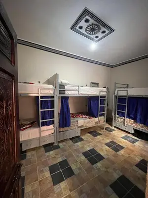 a room with three bunk beds in it at For You Riad Marrakech in Marrakech