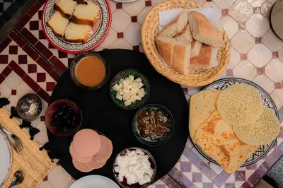 a table topped with plates of food on a table at Riad Ajebel in Marrakech