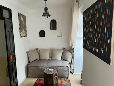 a living room with a couch in a room at Riad SASHA in Marrakech