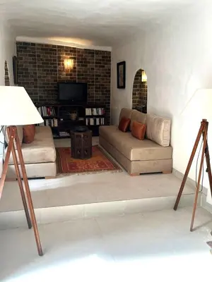 a living room with a couch and a tv at Riad SASHA in Marrakech