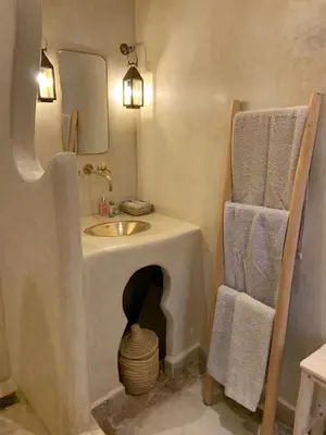 a bathroom with a sink and a mirror at Riad Sin in Marrakech