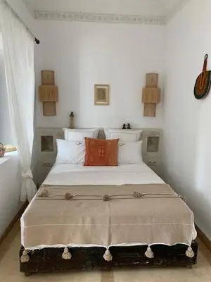 a bedroom with a large bed in a room at Riad Sin in Marrakech