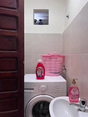 a bathroom with a washing machine and a sink at Dar Tariq 3 suites avec pisicine in Marrakech