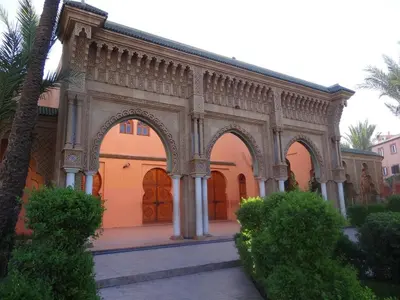 a large building with arches in a courtyard at Dar Tariq 3 suites avec pisicine in Marrakech
