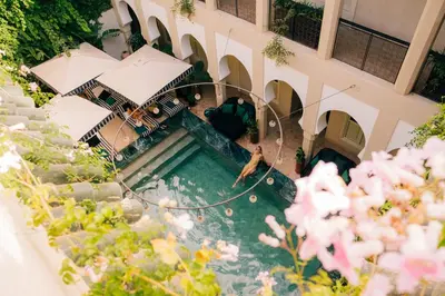 an overhead view of a person jumping in a pool at Riad Nashira & Spa in Marrakech